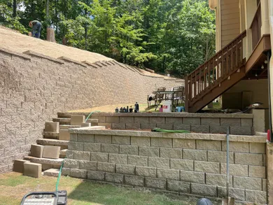 Image of a large newly installed retaining wall next to a home.